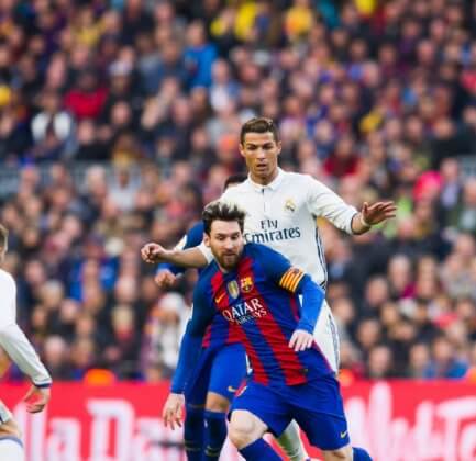 messi vs ronaldo in a football match between Barcelona and Madrid