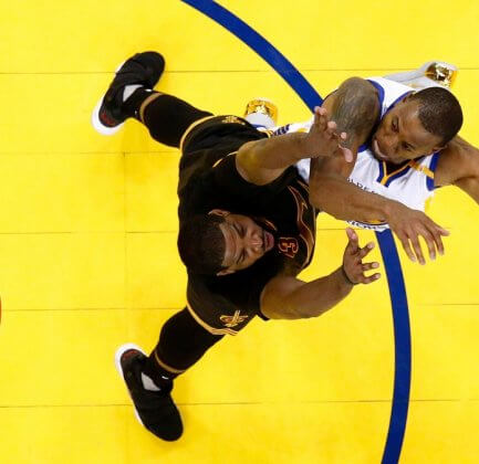 Tristan Thompson #13 of the Cleveland Cavaliers and Andre Iguodala #9 of the Golden State Warriors go up for a loose ball in Game 5 of the 2017 NBA Finals
