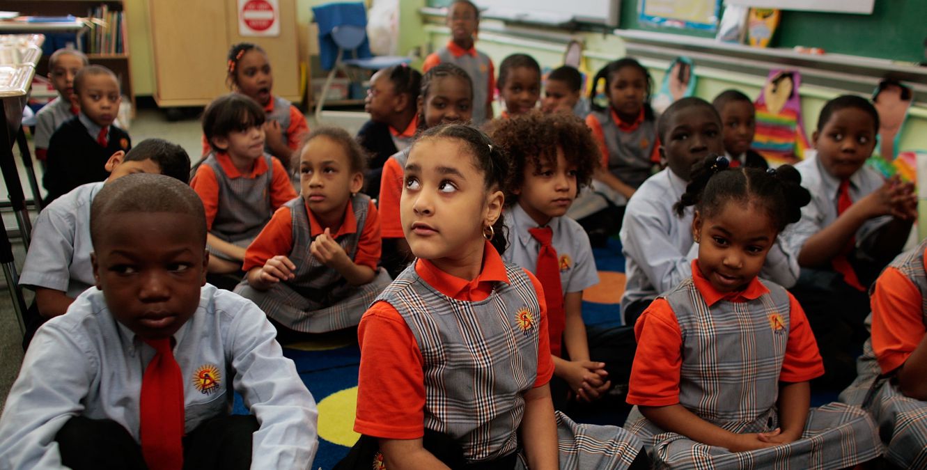 Kids in a New York classroom in school uniforms