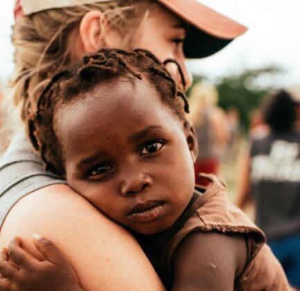 volunteer holding a baby