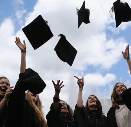 College students throwing caps at graduation.