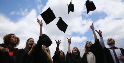 College students throwing caps at graduation.