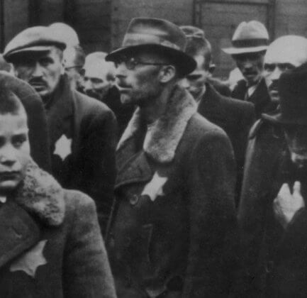 May 1944: Jewish deportees, with the yellow stars sewn on their coats, arrive at Auschwitz concentration camp