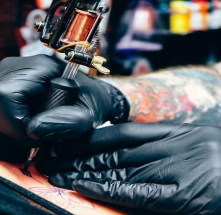A person getting a colorful tattoo as a sign of expression.