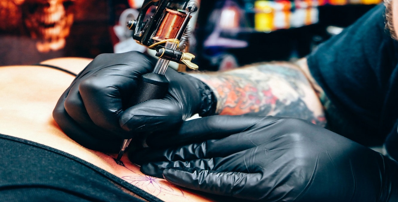 A person getting a colorful tattoo as a sign of expression.