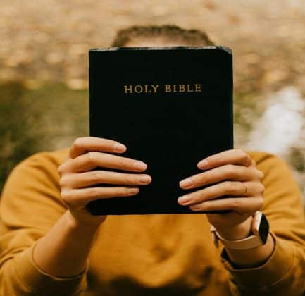 A person holding a Bible