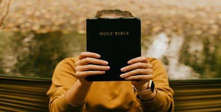 A person holding a Bible